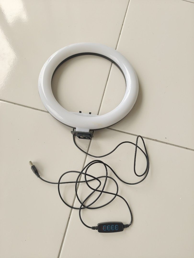 Medium ring light (Category: Lighting & Studio Equipment) located in Singapore. Submitted by munsterusa (Listing ID 1455893699, Image 1). Description: Medium size ring light. USB powered, step dimmer and 3 tones. Comes with tall light stand. Prefer to sell as set..