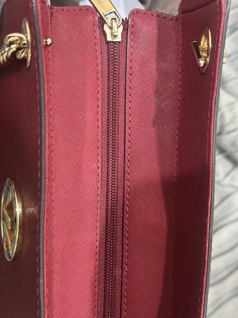 Michael Kors Red Leather Chain Shoulder Bag (Category: Luxury Bags & Wallets) located in Antipolo. Submitted by mowchiii (Listing ID 1455871000, Image 3). Description: - Cherry red colorway - Saffiano leather - Gold-tone chain shoulder handles - Large, spacious tote — perfect for everyday use - Gold chain detailing on straps - Zipper closure at the top - Convenient side pockets - Ideal for everyday use - Has minor stains, as shown in the photos -