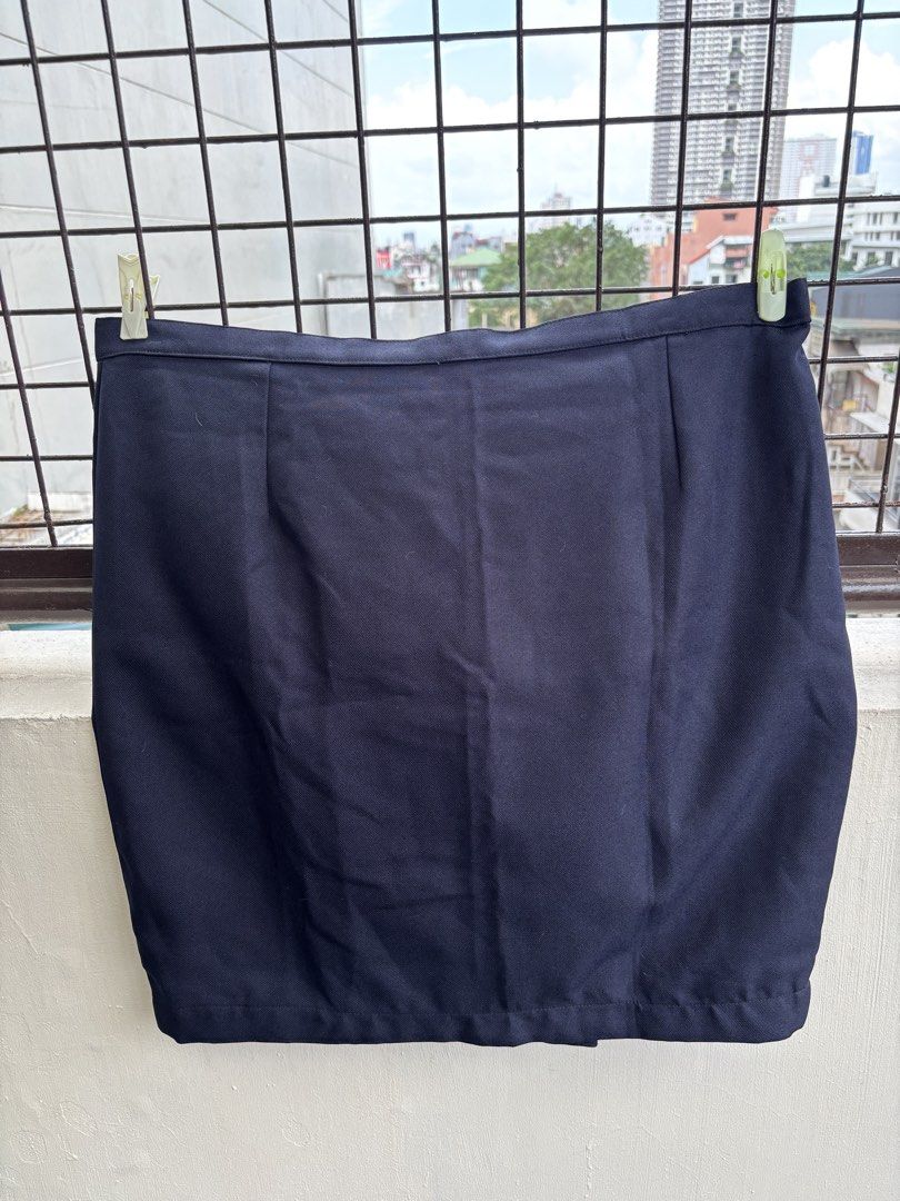 Navy Blue Mini Skirt with Button and Zip Closure (Category: Skirts) located in Manila. Submitted by decluttergivebing (Listing ID 1455907114, Image 1). Description: - Classic navy blue mini skirt - Front button and zip closure - Versatile for casual or work outfits - Effortless to pair with various tops.