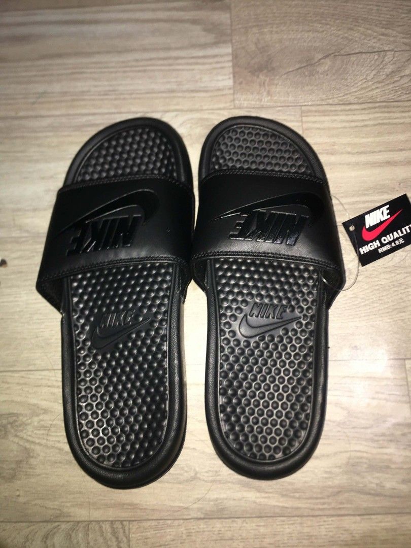 Nike Benassi JDI Slides Black (Category: Slippers & Slides) located in Manila. Submitted by tambay_thriftie (Listing ID 1455864186, Image 1). Description: - Classic black Nike Benassi slides - Comfortable and easy to wear - Features the iconic Nike logo on the strap - Textured sole for enhanced grip - Ideal for casual outings or post-sport relaxation - Comes with original tag.