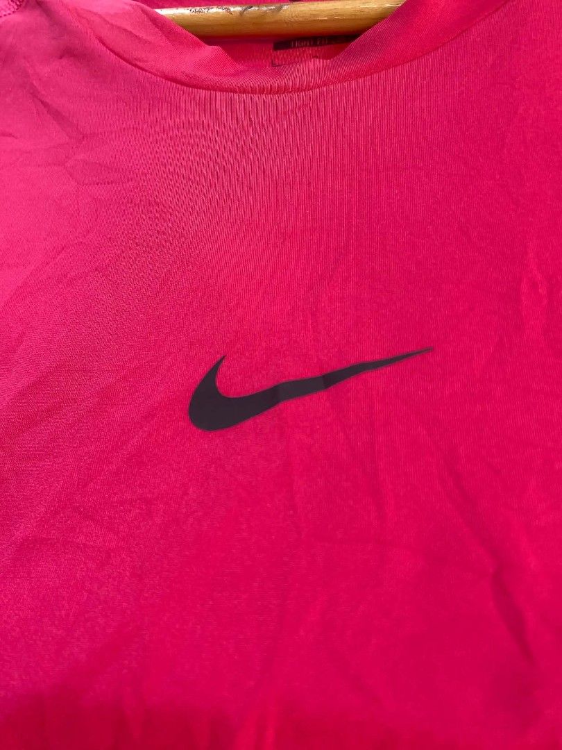 Nike Pro Dri-Fit Long Sleeve Training Shirt (Category: Activewear) located in Trinidad. Submitted by thrifter1997 (Listing ID 1455868462, Image 2). Description: -Dimes(20x28) Strechy pa -Colorate & Condition (10/10) -No Issues - Bright pink Nike Pro Dri-Fit long sleeve shirt - Size: L - Fit: Tight - Material: Polyester and Spandex blend for comfort and flexibility - Features: Nike Swoosh logo on chest, Nike Pro branding on back collar - Origin: M