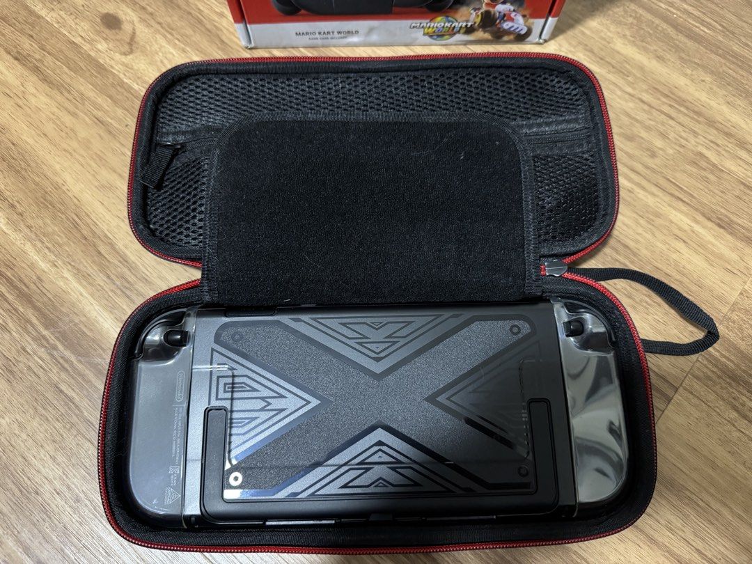 Nintendo Switch 2 (Category: Nintendo) located in Singapore. Submitted by kevinpereira_11 (Listing ID 1455912708, Image 2). Description: - Nintendo Switch 2 Console (Grey) - No scratches or damages, View to believe - Custom design on the back - Black carrying case with red trim and screen protecter - Original packaging included with all accessories that came together when first bought - Ideal for gaming on the go - Used only a few times as busy w