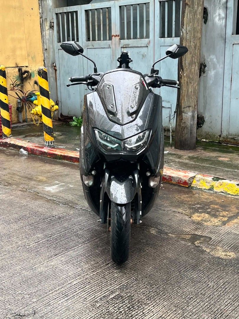 NMAX 155cc Motorcycle (Category: Motorbikes for Sale) located in Mandaluyong City. Submitted by love.riel (Listing ID 1455886901, Image 2). Description: Suzuki NMAX 155cc. Dark grey with carbon fiber accents. Has a phone mount installed. Clean and well-maintained. Ready for the road. Message for inquiries. For sale Open swap Price: 115K nego Nmax 155 v2.1 2024-2025 year model 18k odo Original papers With casa receipt Red code Open dos Id with sig