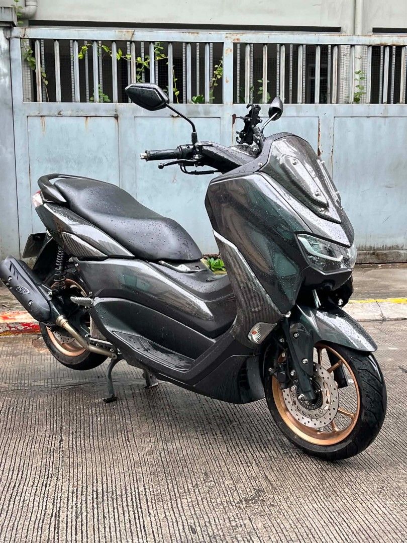 NMAX 155cc Motorcycle (Category: Motorbikes for Sale) located in Mandaluyong City. Submitted by love.riel (Listing ID 1455886901, Image 3). Description: Suzuki NMAX 155cc. Dark grey with carbon fiber accents. Has a phone mount installed. Clean and well-maintained. Ready for the road. Message for inquiries. For sale Open swap Price: 115K nego Nmax 155 v2.1 2024-2025 year model 18k odo Original papers With casa receipt Red code Open dos Id with sig