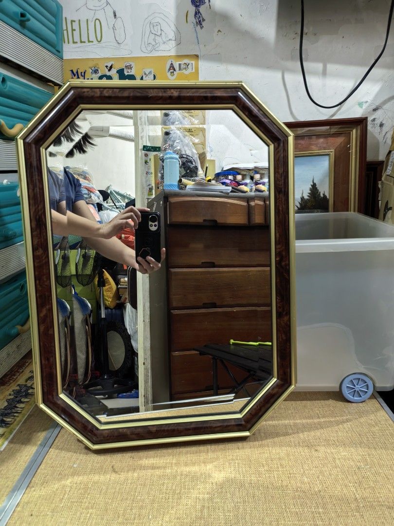 Octagonal Wall Mirror (Category: Mirrors) located in Cebu City. Submitted by dudes_villanueva (Listing ID 1455857543, Image 2). Description: Octagonal Wall Mirror 📌 Features an elongated octagonal shape framed in rich burgundy faux-wood laminate or burl-wood finish, accented with thin gold foil pinstripe trimming along the outer and inner borders. 📌 In excellent condition. Few minor light paint scratches not an issue Measurement: 17x22.5 inches