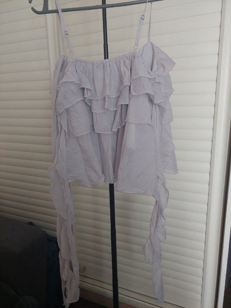 Pastel Purple / Lilac Ruffled Frilly Top (Category: Blouses) located in Manila. Submitted by izzybellz (Listing ID 1455882241, Image 2). Description: - pretty lilac frilly ruffled top with detatchable neck scarf - imitates the likes of a jellyfish so cute! - has double lining and adjustable straps - RFS: need extra funds - originally bought from shop.florice on IG (view last two pictures; disclaimer: used the pictures for reference only credits t