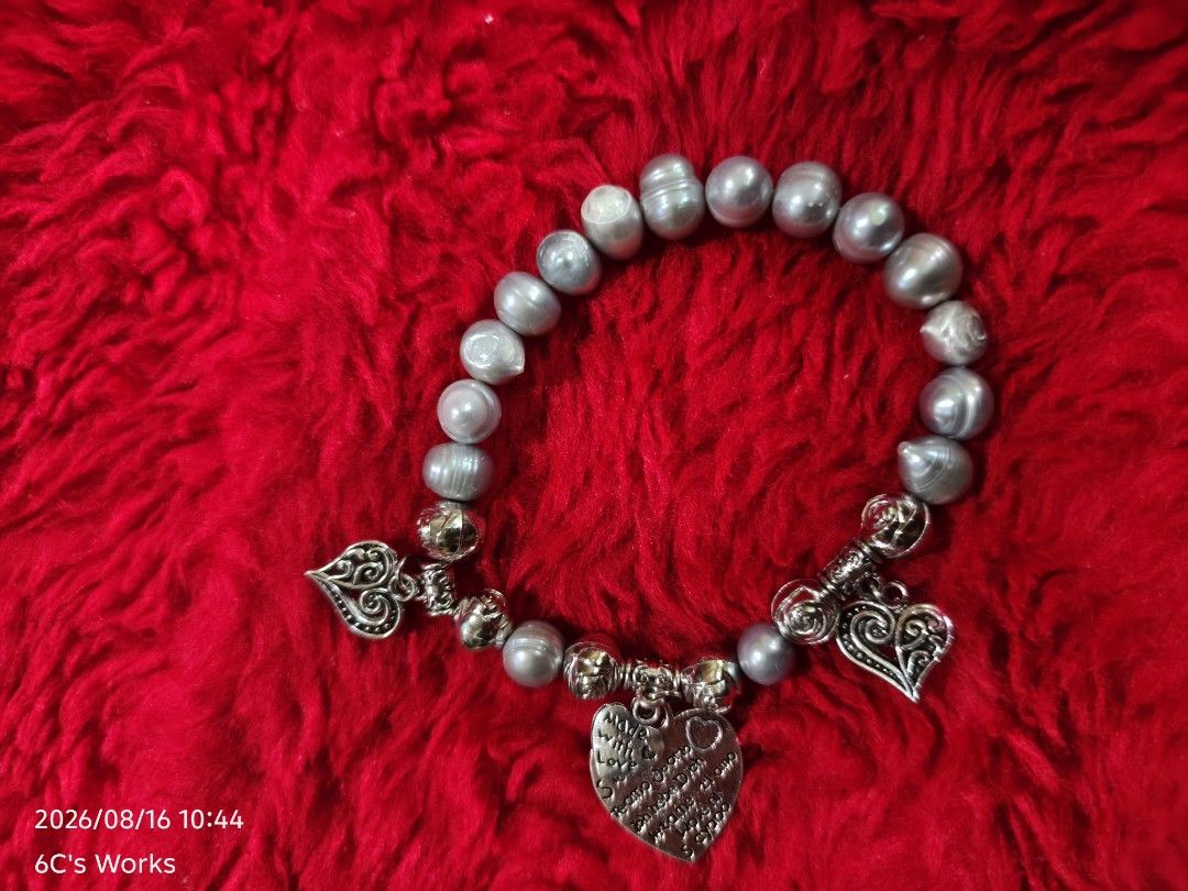 Pearl Bracelet with Heart Charms (Category: Bracelets) located in Consolacion. Submitted by mencytte (Listing ID 1455870049, Image 2). Description: - Grey pearl bracelet - Silver-tone charms - Heart-shaped charms - Rose detail charms - 'Made with love' engraved charm - Charm with a quote - Unique design - Ideal for gifts or personal use.