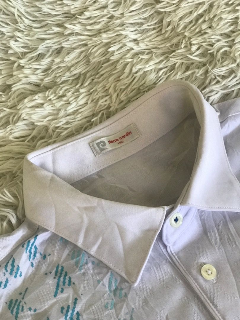 Pierre Cardin White Polo Shirt with Blue Pattern (Category: Tshirts & Polo Shirts ) located in Caloocan City. Submitted by iruzen_0997 (Listing ID 1456012593, Image 2). Description: - Brand: Pierre Cardin - Color: White with blue geometric pattern - Sleeve Length: Short sleeves with blue trim - Neckline: Button-up - Style: Casual, Golf wear.
