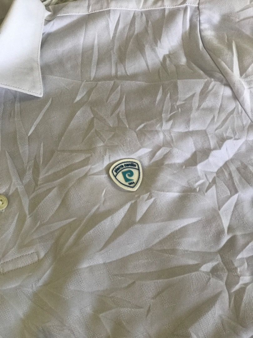 Pierre Cardin White Polo Shirt with Blue Pattern (Category: Tshirts & Polo Shirts ) located in Caloocan City. Submitted by iruzen_0997 (Listing ID 1456012593, Image 3). Description: - Brand: Pierre Cardin - Color: White with blue geometric pattern - Sleeve Length: Short sleeves with blue trim - Neckline: Button-up - Style: Casual, Golf wear.