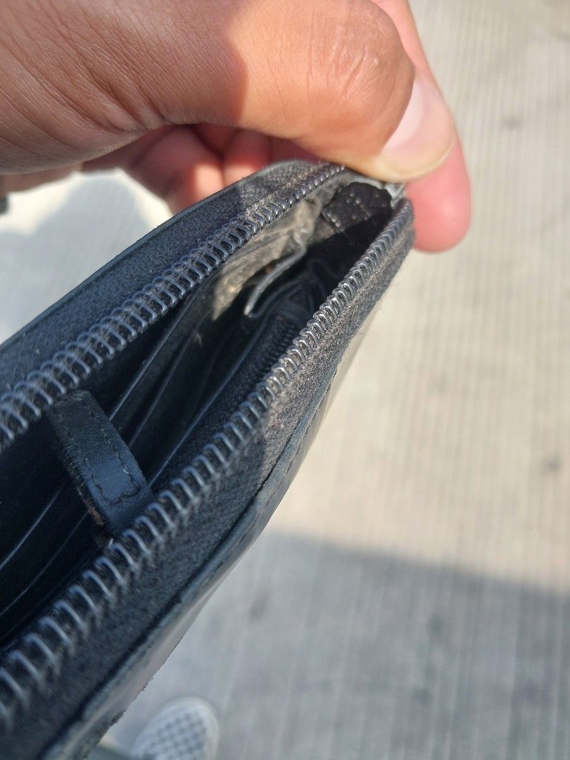 Prada Milano Black Leather Zip Around Wallet (Category: Luxury Bags & Wallets) located in Polomolok. Submitted by warmfire.3185dd (Listing ID 1455917481, Image 3). Description: - Authentic Prada Milano wallet - Black leather, zip-around style - Shows some signs of wear (exterior & interior) - LAMPO ZIPPER - Zipper functions smoothly - Ample card slots and compartments.