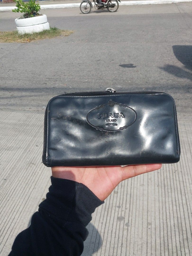 Prada Milano Black Leather Zip Around Wallet (Category: Luxury Bags & Wallets) located in Polomolok. Submitted by warmfire.3185dd (Listing ID 1455917481, Image 1). Description: - Authentic Prada Milano wallet - Black leather, zip-around style - Shows some signs of wear (exterior & interior) - LAMPO ZIPPER - Zipper functions smoothly - Ample card slots and compartments.