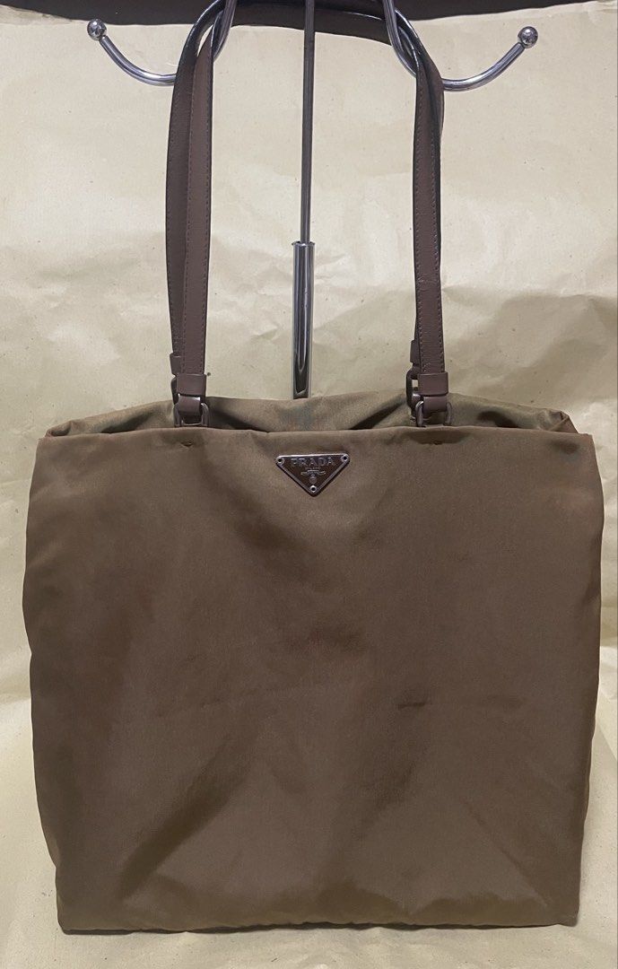 Prada Nylon Tote Bag (Category: Luxury Bags & Wallets) located in Manila. Submitted by ermenchita71969 (Listing ID 1456000807, Image 1). Description: - Authentic Prada tote bag - Color: Gold & brown - Material: Durable nylon with leather handles - Interior: Features iconic Prada logo pattern - Spacious design, ideal for everyday essentials - Perfect for daily use - very light & spacious - with Certificate of Authentication.