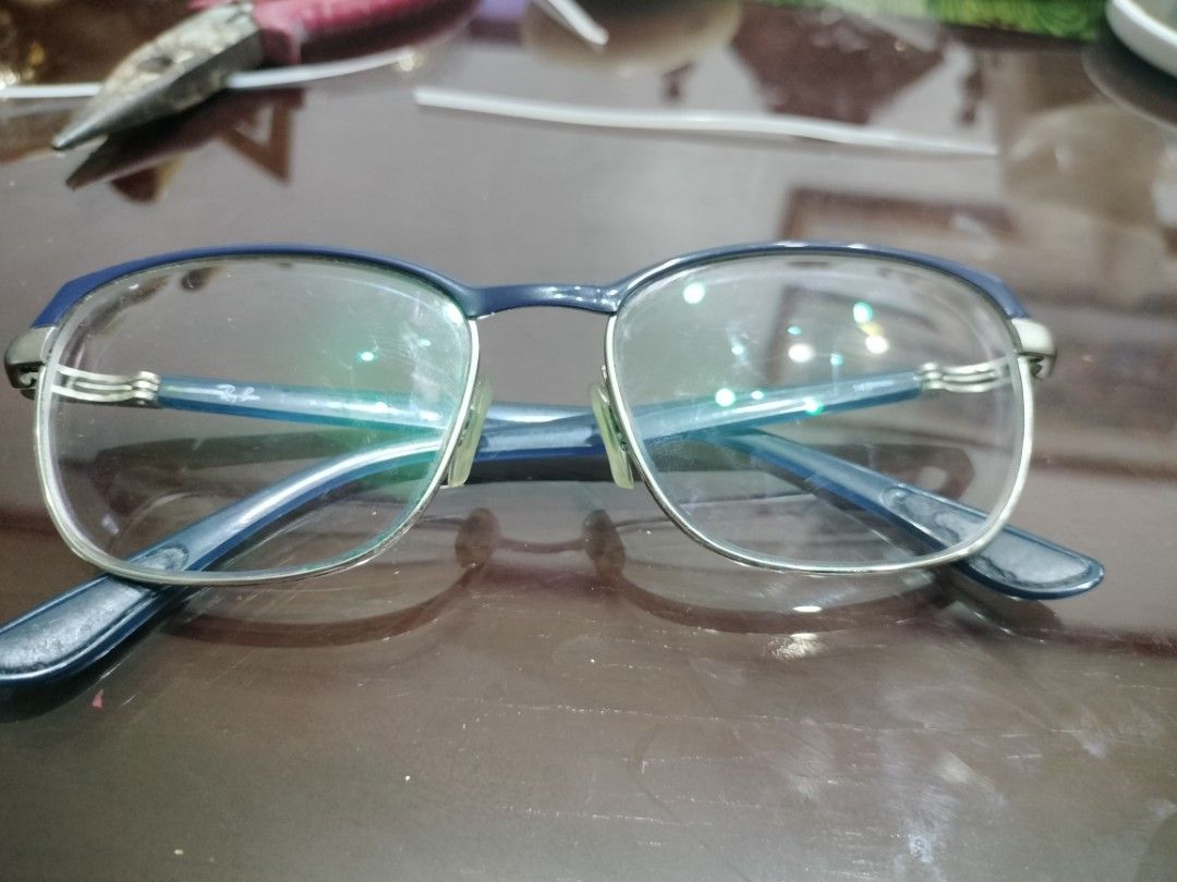 Ray-Ban Eyeglasses Frame Blue Silver Metal (Category: Sunglasses & Eyewear) located in Cavite. Submitted by indigence (Listing ID 1455881500, Image 1). Description: - Brand: Ray-Ban - Frame Material: Blue and silver metal - Frame Details: Blue arms with silver accents - Lens Width: 54mm - Bridge Width: 17mm - Arm Length: 145mm - Condition: Prescription lenses need replacement. Minor scuffs on frame. 100% original or authentic rfs: upgrade note: p