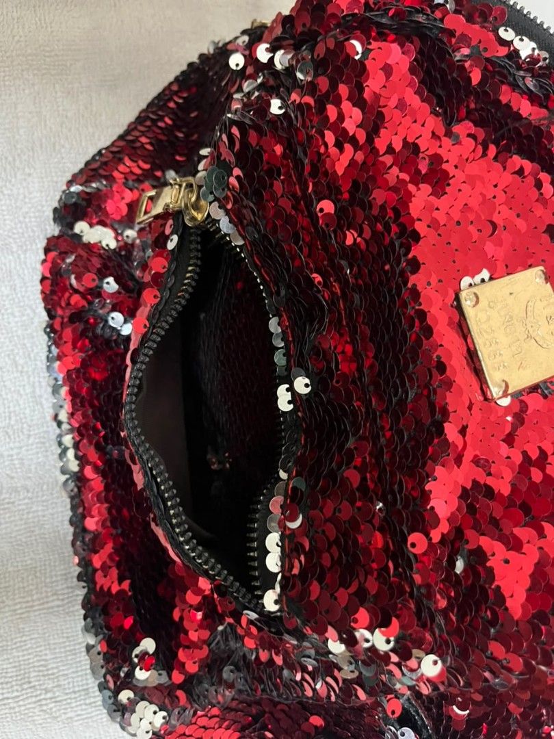Red Sequin Mini Backpack (Category: Backpacks) located in Kuala Lumpur. Submitted by narresh_. (Listing ID 1455894652, Image 3). Description: - Eye-catching sparkly red sequin mini backpack - Features a convenient front zipper pocket - Spacious main compartment for your essentials - Adjustable black straps for a comfortable fit - Stylish gold hardware details - Ideal for parties, nights out, or travel adventures.