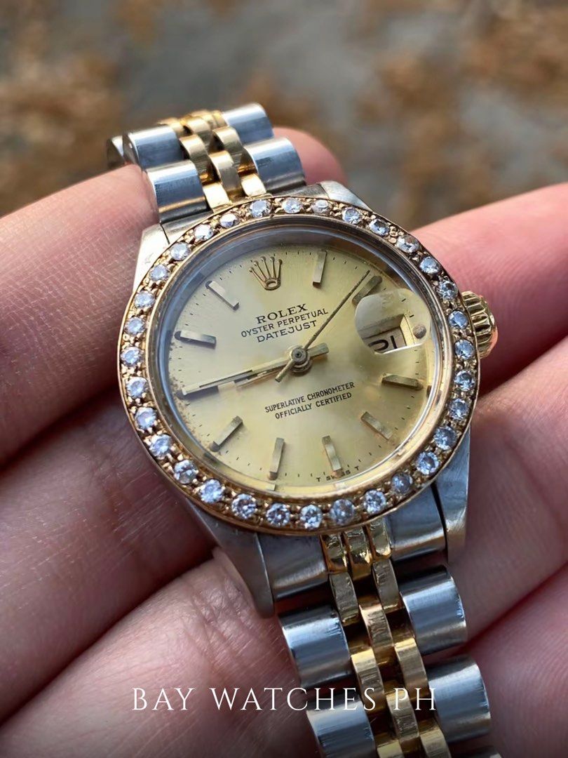 ROLEX Oyster Perpetual 26mm Custom Diamond Bezel (Category: Luxury Watches) located in Bulacan. Submitted by baywatchesph (Listing ID 1455907236, Image 2). Description: ROLEX Oyster Perpetual 26mm Custom Diamond Bezel Ref. 69173 Automatic movement 26mm case diameter Date display at the 3 o’clock position Custom diamond bezel Two-tone stainless steel & 18K gold 9/10 - In good condition With box and manual. See to appreciate..
