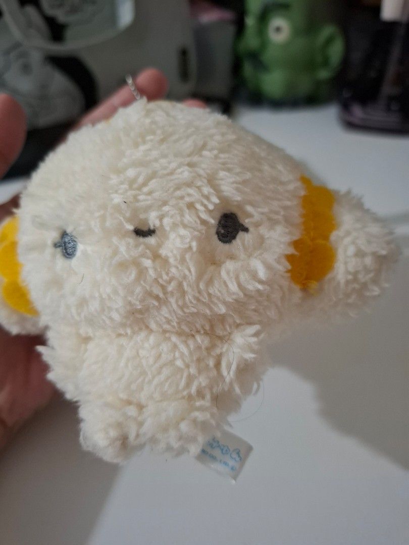 Sanrio Cogimyun charm plushie (Category: Plushies & Soft Toys) located in Orion. Submitted by timburtonfan (Listing ID 1455978837, Image 2). Description: - Adorable white fluffy plush keychain - Features charming yellow accents on top and bottom - Includes a small yellow patch with a red detail on the side - Comes with a durable metal keychain ring - Ideal accessory for decorating bags, backpacks, and more!.