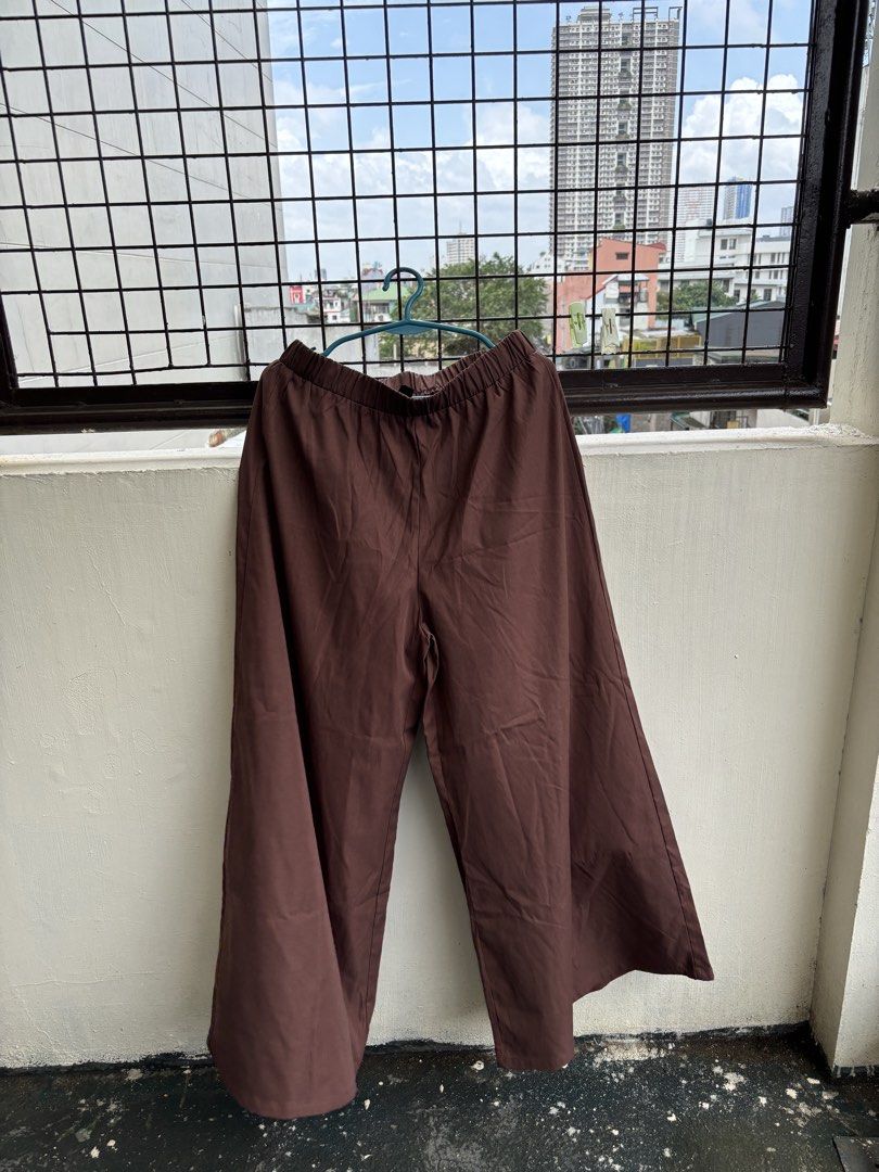 SHEIN Brown Wide Leg Pants Size L (Category: Other Bottoms) located in Manila. Submitted by decluttergivebing (Listing ID 1455907648, Image 1). Description: - Brand: SHEIN - Style: Wide leg pants - Color: Brown - Features: Elastic waistband for comfort - Size: L - Fits: 40/42 EU or 8/10 US - Occasion: Casual wear - Styling: Easy to pair with different tops.