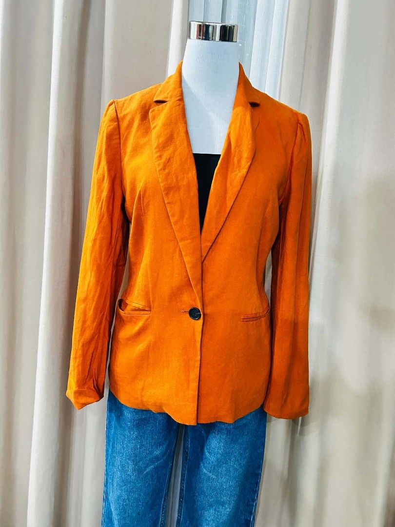 SM Woman Orange Single Button Blazer (Category: Coats, Jackets and Outerwear) located in Bulacan. Submitted by declutterwithme4 (Listing ID 1455935603, Image 1). Description: - Vibrant bright orange blazer - Single button front closure - Two functional flap pockets on the sides - Effortlessly pairs with jeans or trousers - Adds a perfect pop of color to any outfit - Suitable for both casual and semi-formal occasions.
