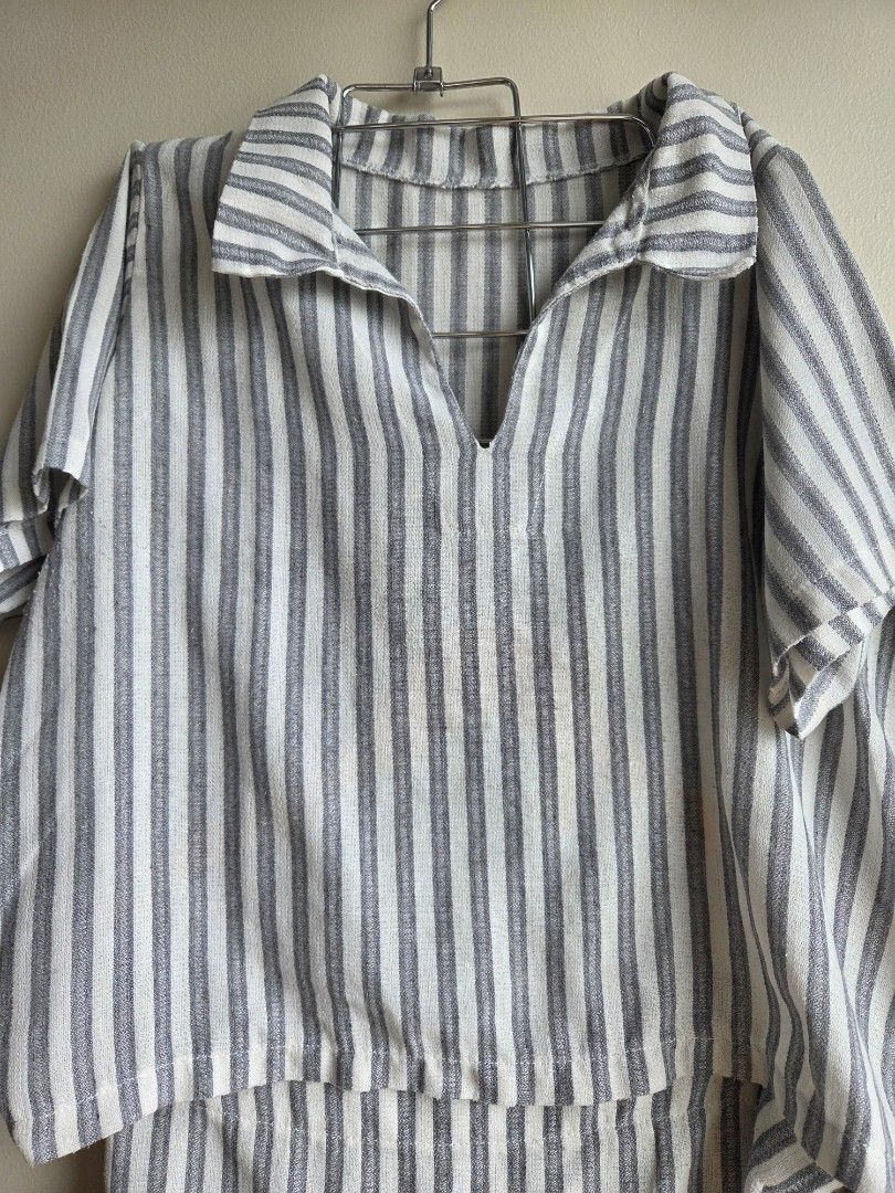Striped Button-Up Shirt with Tie Detail (Category: Shirts) located in Quezon City. Submitted by strwbry.ph (Listing ID 1455906967, Image 3). Description: - Stylish grey and white stripe pattern - Classic button-up front - Unique tie detail at the collar - Long sleeves with cuffs - Lightweight, breathable fabric (feels like linen or cotton blend) - Versatile for casual to smart-casual outfits - Effortless to style - Fits M to L.