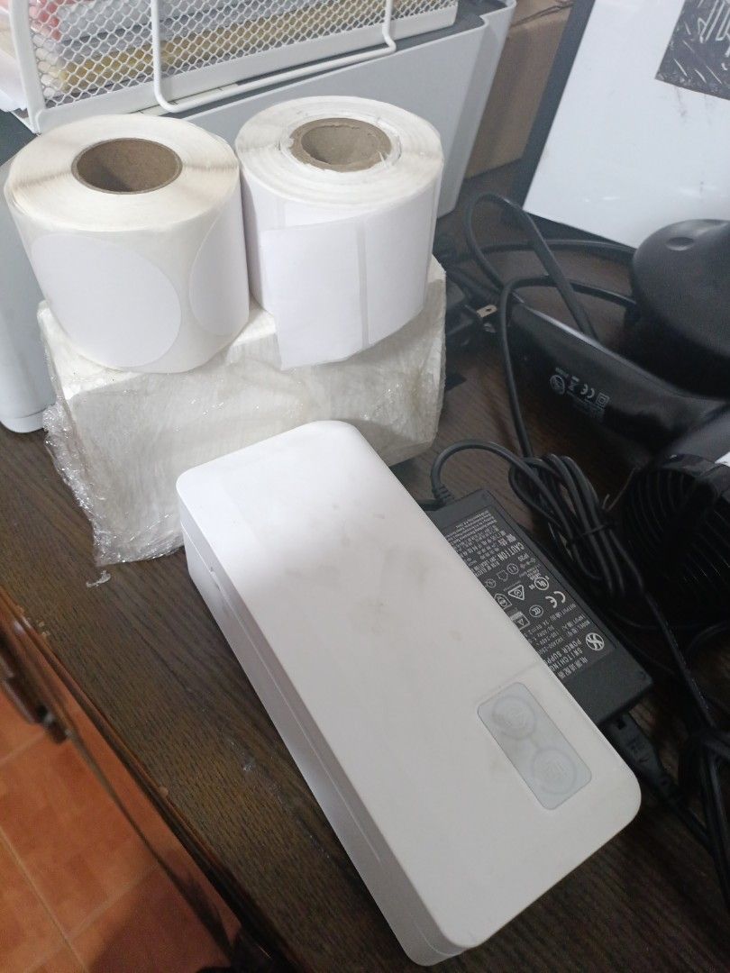 Thermal Printer A6 with Power Adapter and Label Rolls (Category: Printers, Scanners & Copiers) located in Quezon City. Submitted by catsdeclutter (Listing ID 1455913023, Image 1). Description: - Includes power adapter - Comes with 2 rolls of blank labels (1 round, 1 rectangular) - Useful for shipping needs - All items in good, working condition -Will Pm you app to use once purchased.