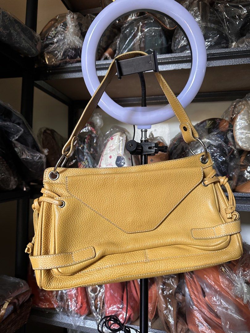 TOD'S Butter Yellow Leather Shoulder Bag (Category: Luxury Bags & Wallets) located in Butuan. Submitted by slownsteady_ (Listing ID 1455930108, Image 2). Description: - Authentic TOD'S butter yellow leather shoulder bag - Textured leather exterior with stylish buckle details - Secure zip closure for the main compartment - Interior zip pocket for essentials - Adjustable straps for a customized fit - Ideal everyday bag for a touch of luxury.
