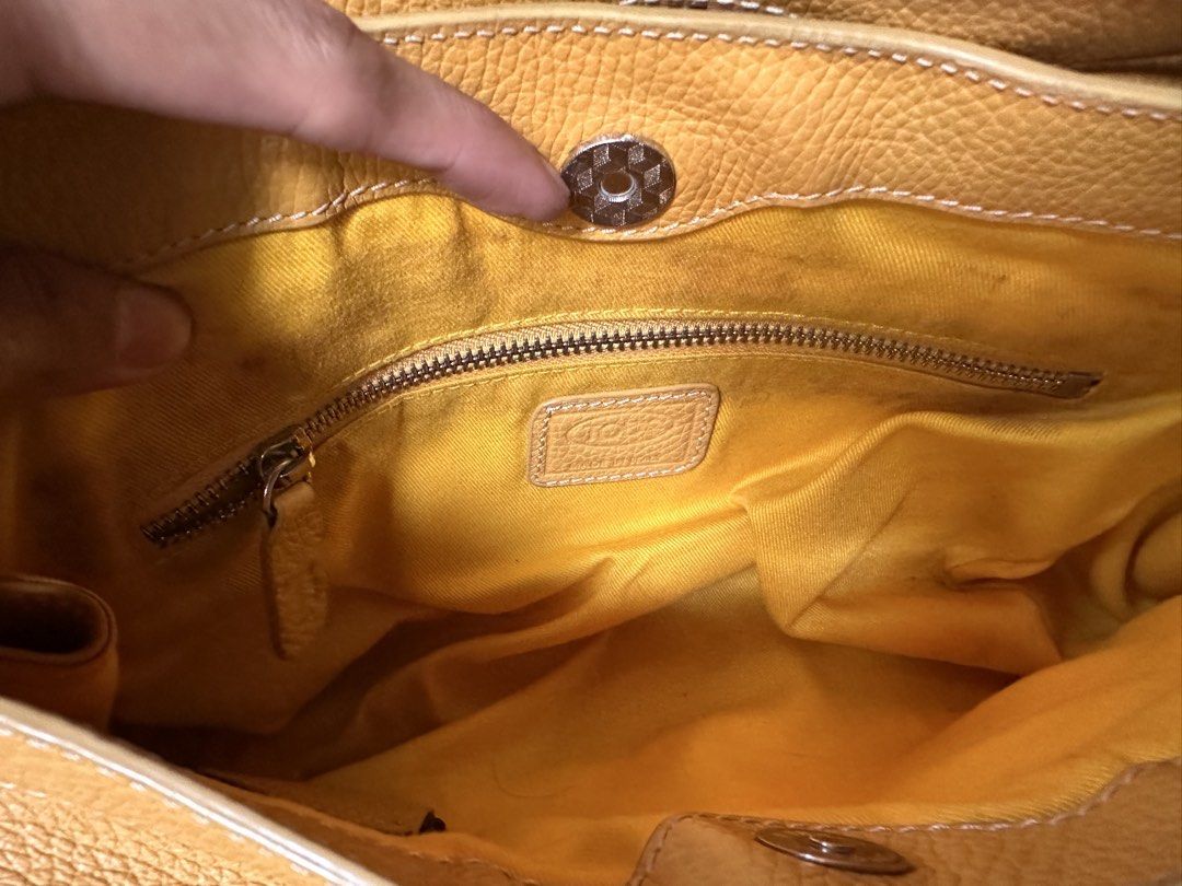 TOD'S Butter Yellow Leather Shoulder Bag (Category: Luxury Bags & Wallets) located in Butuan. Submitted by slownsteady_ (Listing ID 1455930108, Image 3). Description: - Authentic TOD'S butter yellow leather shoulder bag - Textured leather exterior with stylish buckle details - Secure zip closure for the main compartment - Interior zip pocket for essentials - Adjustable straps for a customized fit - Ideal everyday bag for a touch of luxury.