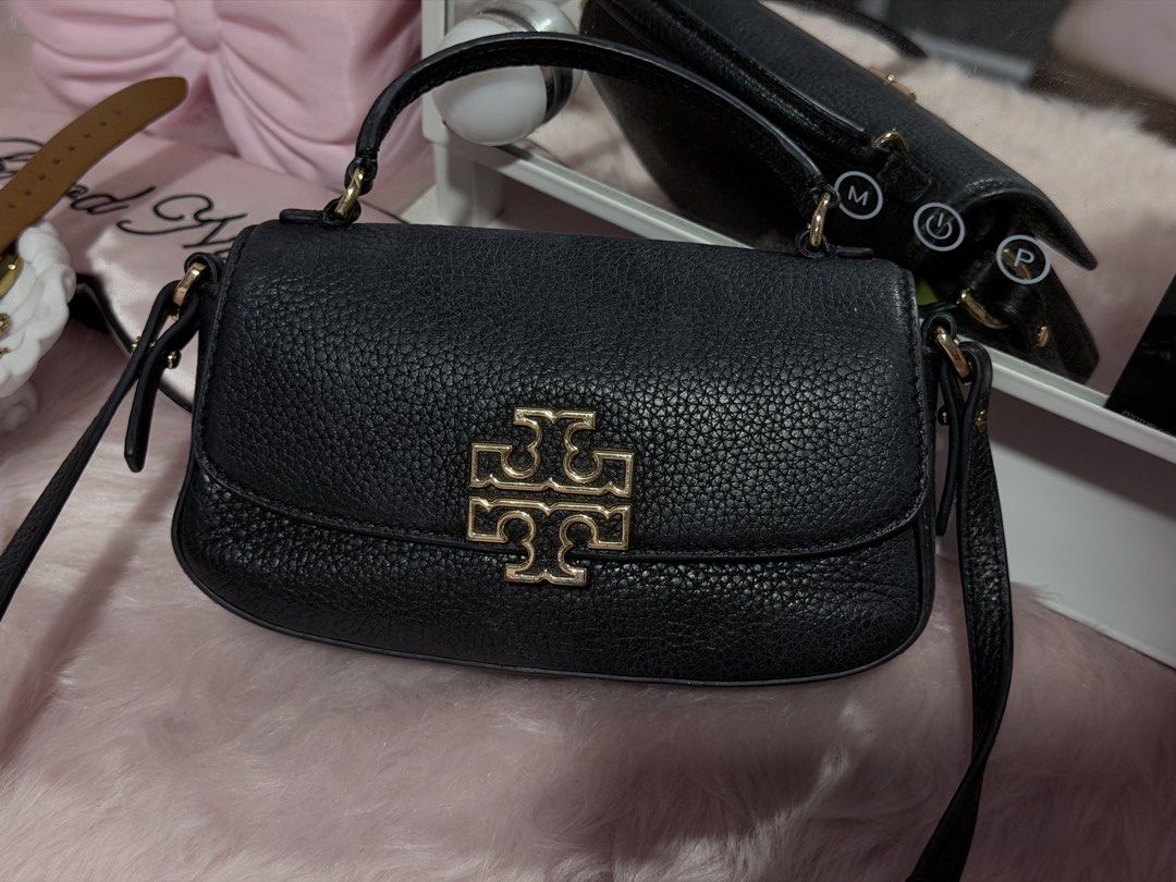 Tory Burch Britten Black Leather Mini Top Handle Bag (Category: Luxury Bags & Wallets) located in Cauayan City . Submitted by rianna12_ (Listing ID 1455873637, Image 1). Description: Original/Authentic Tory butch mini britten rfs: decluttering minor flaws: seen on picture can fit a lot! bought for 12k still negotiable alagang alaga still looking new .
