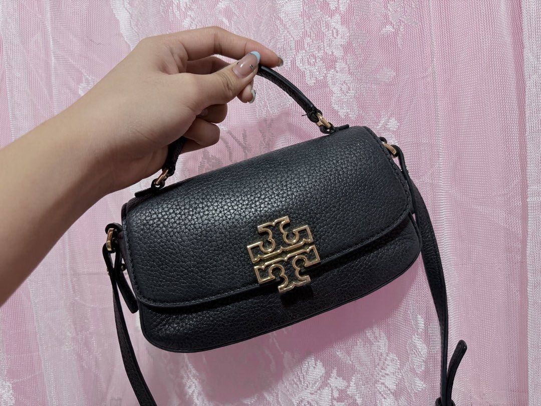Tory Burch Britten Black Leather Mini Top Handle Bag (Category: Luxury Bags & Wallets) located in Cauayan City . Submitted by rianna12_ (Listing ID 1455873637, Image 2). Description: Original/Authentic Tory butch mini britten rfs: decluttering minor flaws: seen on picture can fit a lot! bought for 12k still negotiable alagang alaga still looking new .