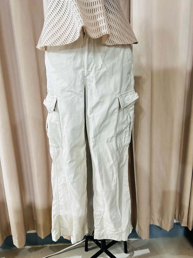 Uniqlo Cream Cargo Pants (Category: Other Bottoms) located in Bulacan. Submitted by declutterwithme4 (Listing ID 1455976303, Image 1). Description: - Cream colored cargo pants - Button and zip front closure - Ideal for casual wear - Versatile for styling with various tops - Waist: 30-33 inches, Length 39 inches.