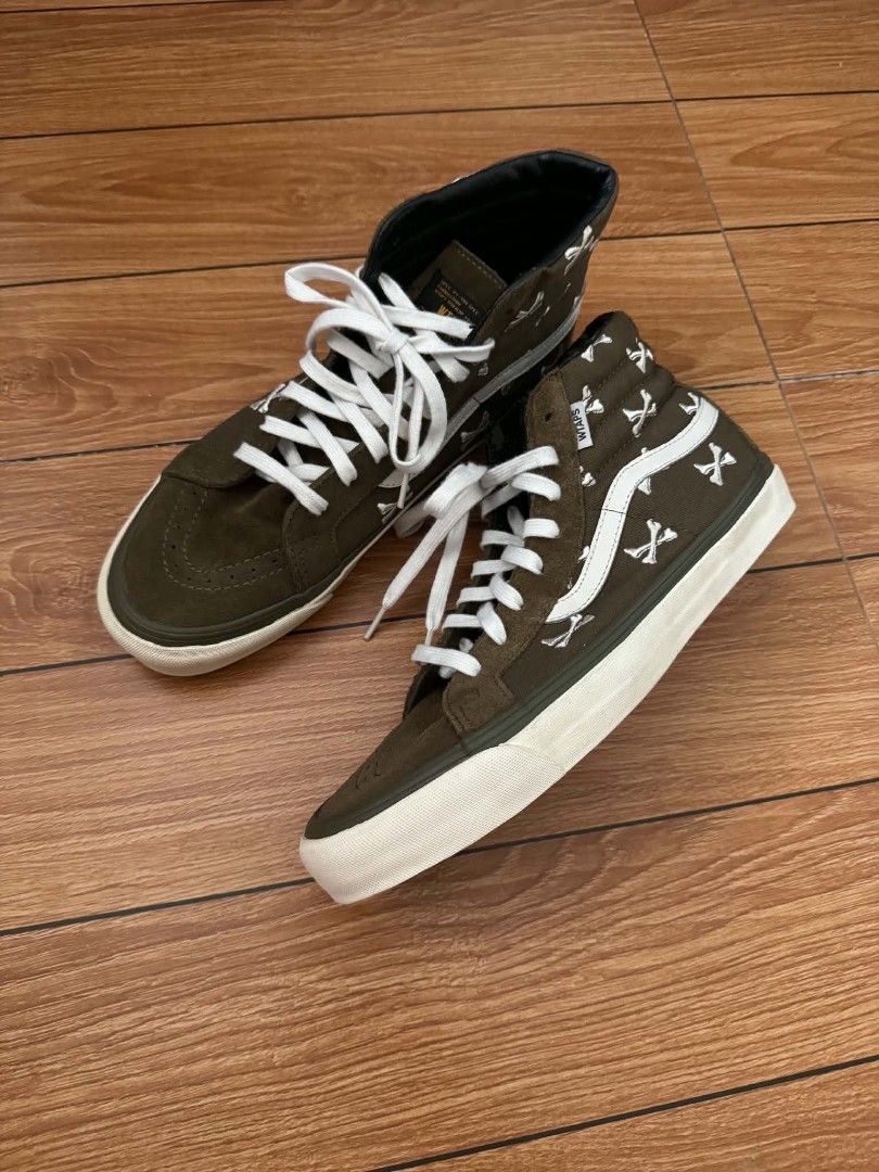 Vans Sk8-Hi WTAPS Crossbones Olive (Category: Sneakers) located in San Pedro. Submitted by madvillainkicks (Listing ID 1455878107, Image 1). Description: - Vans Sk8- WTAPS - Color: Olive Green - Iconic WTAPS crossbones pattern on side - Suede upper - White laces and sole - High-top silhouette - Ideal for casual wear.