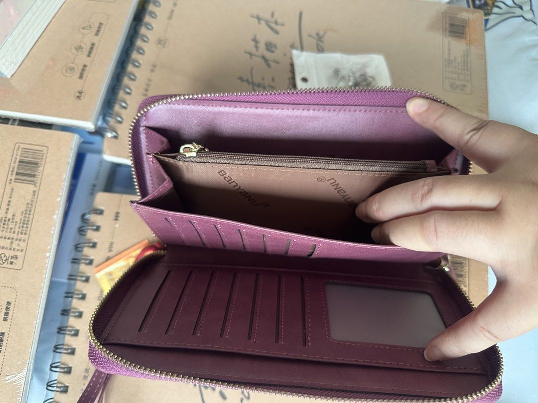 wallets (Category: Wallets & Card Holders) located in Singapore. Submitted by gemma.jia (Listing ID 1455951188, Image 3). Description: - Stylish plum-colored wallet - Multiple card slots for organization - Zippered compartment for coins/small items - Comes with a convenient wrist strap - Sleek and practical design.