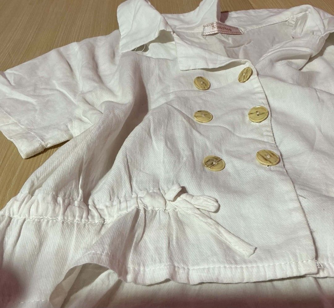 White Double-Breasted Short Sleeve Blouse with Drawstring Waist (Category: Blouses) located in Manila. Submitted by daisyparl (Listing ID 1456029723, Image 2). Description: - White short sleeve blouse - Double-breasted button front - Drawstring waist with ruffled hem - Collar neckline - Versatile for casual or dressy looks.