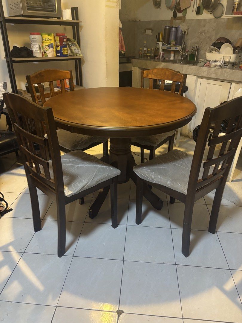 Wooden Round Dining Table with 4 Chairs (Category: Tables & Sets) located in Pasig City. Submitted by lhengay (Listing ID 1455982226, Image 1). Description: - Round wooden dining table - Includes 4 matching chairs - Sturdy pedestal base for the table - Cushioned seats on chairs for comfort - Ideal for small to medium dining spaces - Ready for a new home - Pickup only Moving out sale.. malaki sya para sa lilipatan namin..Halos bago pa po talaga ki