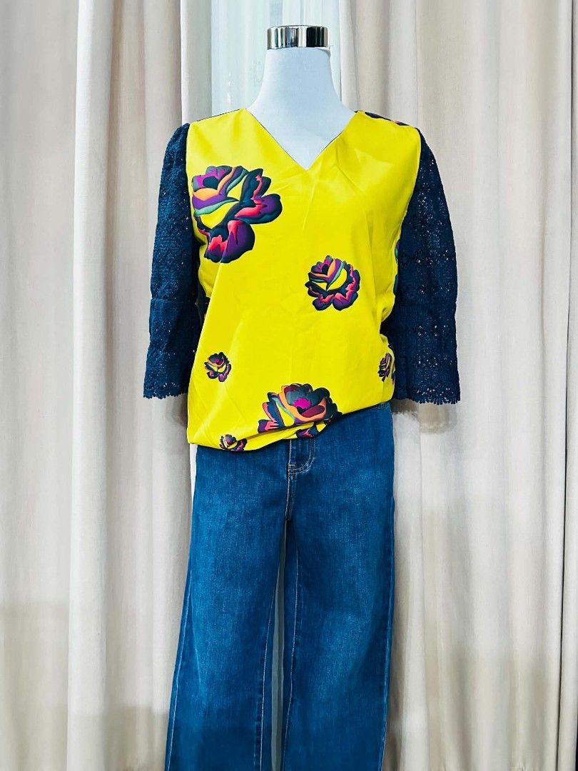 Yellow Floral Top / Blouse (Category: Blouses) located in Bulacan. Submitted by declutterwithme4 (Listing ID 1455894898, Image 1). Description: - Bright yellow V-neck top - Features colorful floral print - Dark lace sleeves - Paired with dark wash, wide-leg denim jeans - Bold and stylish outfit - Comfortable for casual or evening wear.