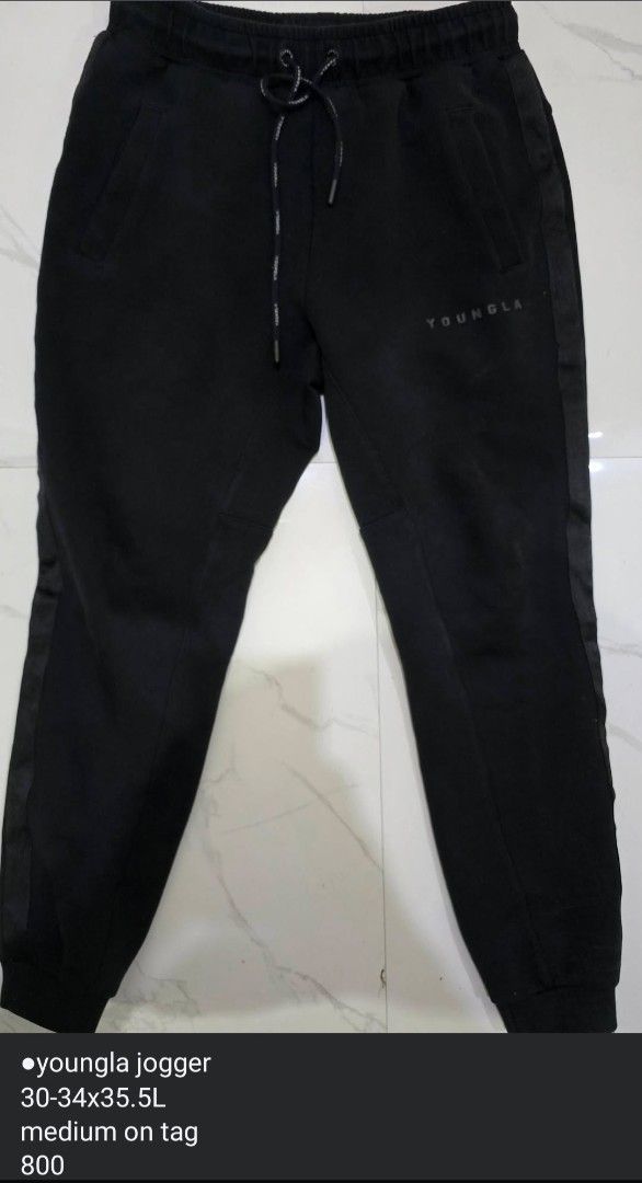 YOUNGLA Joggers Black Size Medium 30-34x35.5L (Category: Joggers) located in La Trinidad. Submitted by odin21 (Listing ID 1455873860, Image 1). Description: - Black YOUNGLA joggers - Size: Medium (fits waist 30-34 inches) - Length: 35.5 inches - Elastic waistband with drawstring - Stylish side stripe detail - Convenient pockets: 2 side, 1 back - Perfect for comfortable everyday wear.