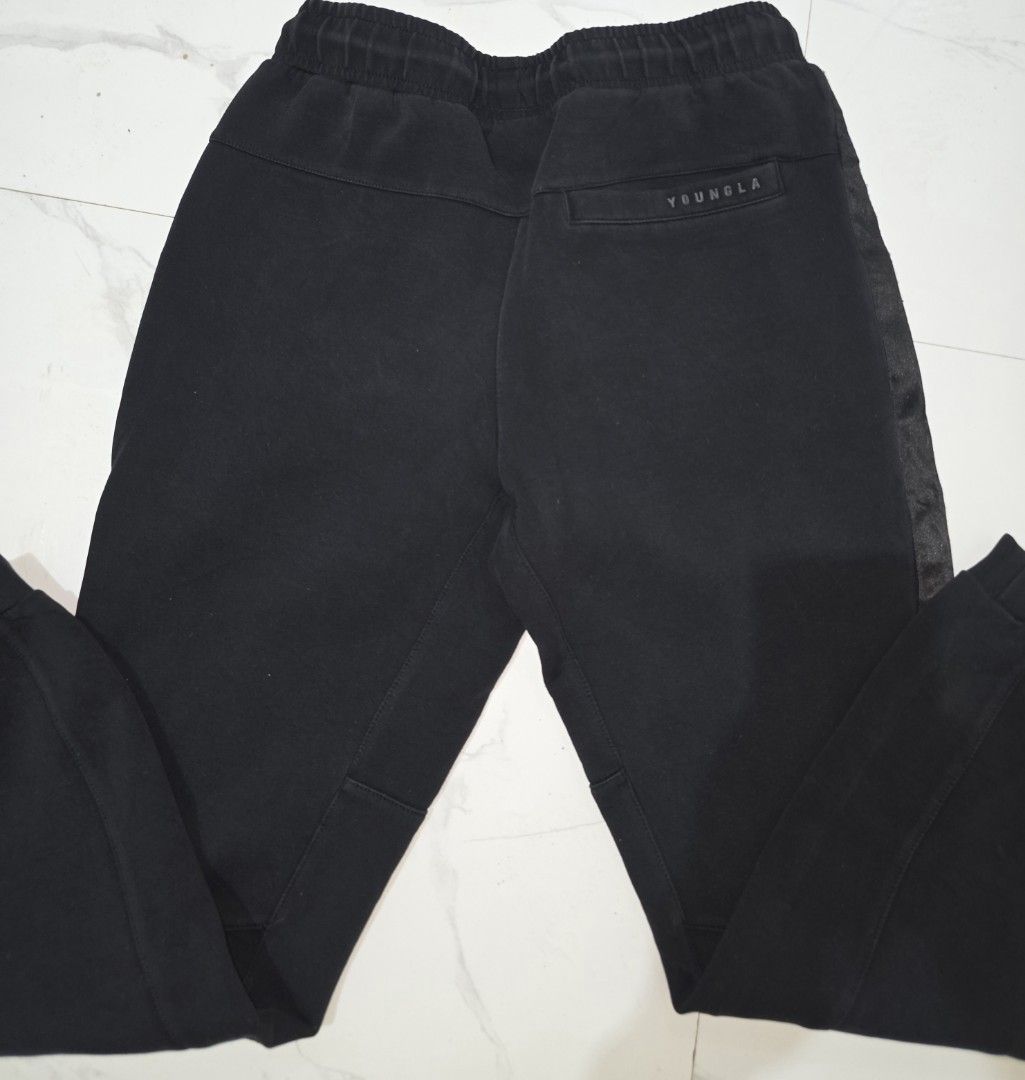 YOUNGLA Joggers Black Size Medium 30-34x35.5L (Category: Joggers) located in La Trinidad. Submitted by odin21 (Listing ID 1455873860, Image 3). Description: - Black YOUNGLA joggers - Size: Medium (fits waist 30-34 inches) - Length: 35.5 inches - Elastic waistband with drawstring - Stylish side stripe detail - Convenient pockets: 2 side, 1 back - Perfect for comfortable everyday wear.
