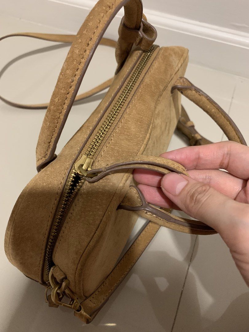 Zara Suede Mini Duffle Bag (Category: Luxury Bags & Wallets) located in Pasig City. Submitted by bsdelacruz (Listing ID 1455889279, Image 2). Description: - Zara tan suede mini duffle bag - Features top handles and a detachable crossbody strap - Secure zipper closure - Interior small zip pocket - Perfect for everyday or evening use.