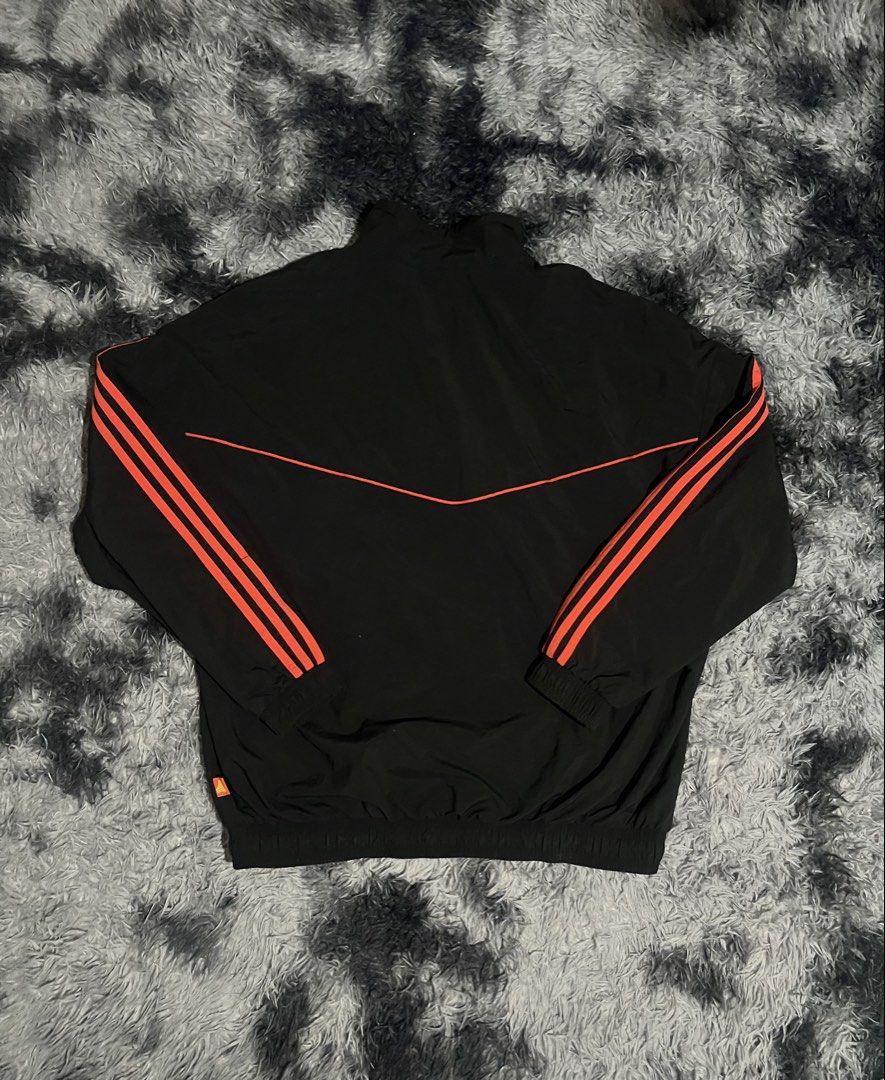 Adidas Track Jacket Black Orange Stripes (Category: Coats, Jackets and Outerwear) located in Cebu City. Submitted by drip_block (Listing ID 1456066015, Image 2). Description: Dimes 26x29 - Classic black Adidas track jacket - Iconic orange stripes on sleeves and chest - Zip-up front with stand-up collar - Elasticated cuffs and hem - Versatile for sports or casual wear.