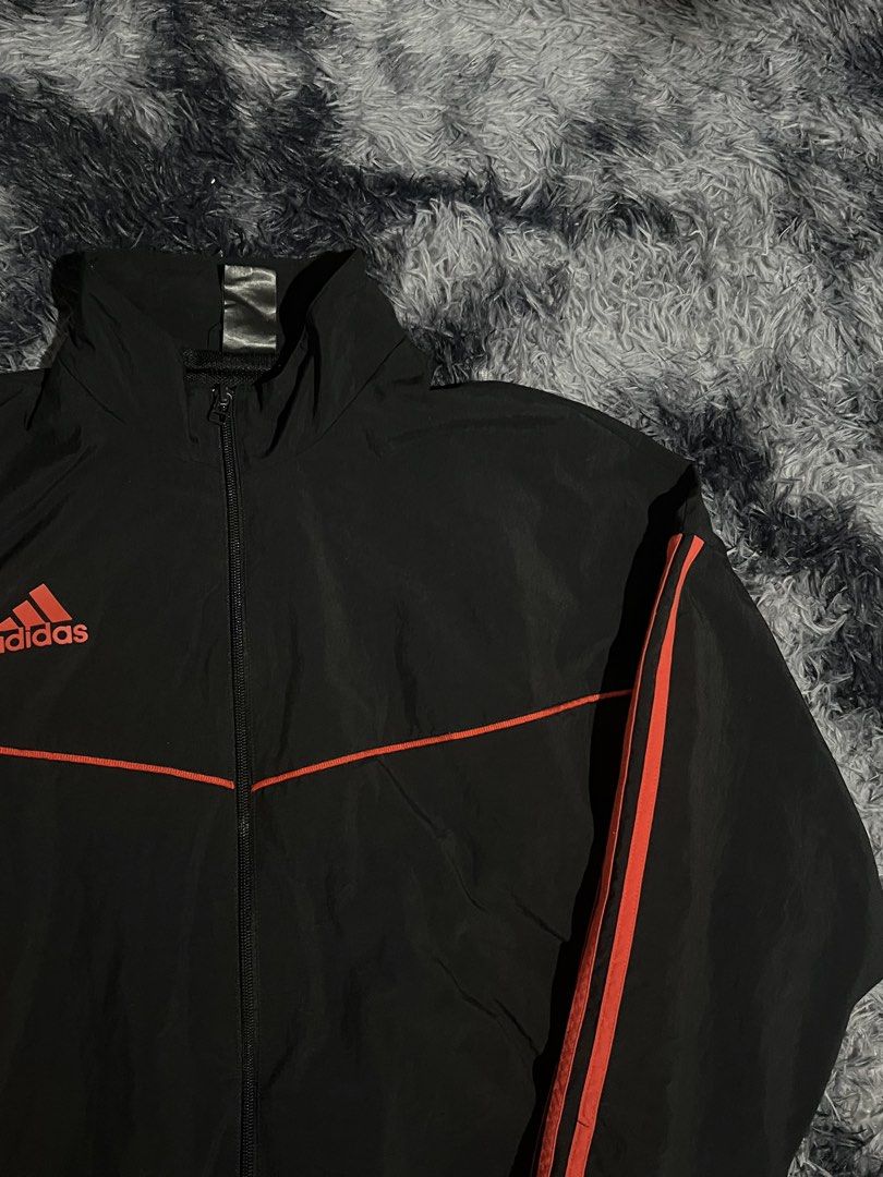 Adidas Track Jacket Black Orange Stripes (Category: Coats, Jackets and Outerwear) located in Cebu City. Submitted by drip_block (Listing ID 1456066015, Image 3). Description: Dimes 26x29 - Classic black Adidas track jacket - Iconic orange stripes on sleeves and chest - Zip-up front with stand-up collar - Elasticated cuffs and hem - Versatile for sports or casual wear.