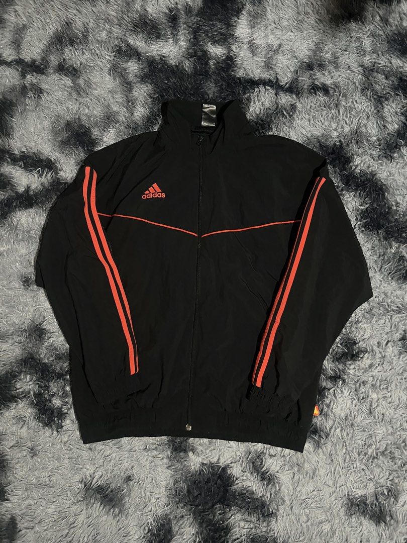 Adidas Track Jacket Black Orange Stripes (Category: Coats, Jackets and Outerwear) located in Cebu City. Submitted by drip_block (Listing ID 1456066015, Image 1). Description: Dimes 26x29 - Classic black Adidas track jacket - Iconic orange stripes on sleeves and chest - Zip-up front with stand-up collar - Elasticated cuffs and hem - Versatile for sports or casual wear.