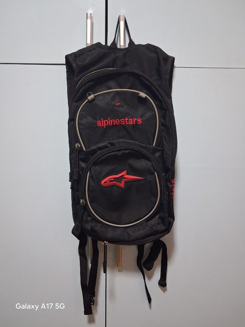 Alpinestars Black Hydration Pack Backpack (Category: Backpacks) located in Imus. Submitted by jefflac54673 (Listing ID 1456067821, Image 1). Description: - Alpinestars hydration pack in sleek black. - Features multiple zippered compartments for secure storage. - Adjustable straps ensure a comfortable, customized fit. - Enhanced visibility with reflective strips on the back. - Ideal for motorcycle rides, cycling, hiking, and other outdoor adventur