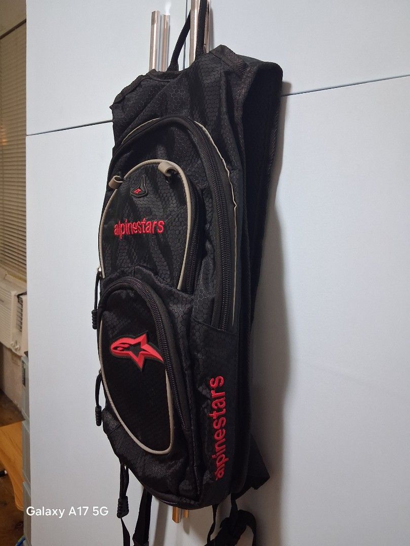 Alpinestars Black Hydration Pack Backpack (Category: Backpacks) located in Imus. Submitted by jefflac54673 (Listing ID 1456067821, Image 2). Description: - Alpinestars hydration pack in sleek black. - Features multiple zippered compartments for secure storage. - Adjustable straps ensure a comfortable, customized fit. - Enhanced visibility with reflective strips on the back. - Ideal for motorcycle rides, cycling, hiking, and other outdoor adventur