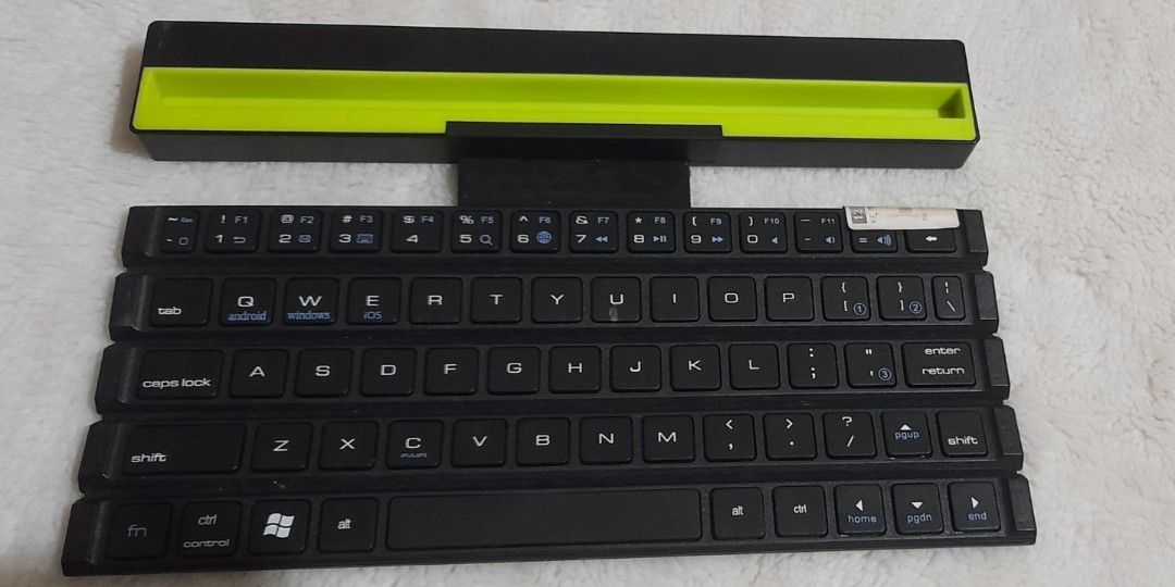 Black Foldable Bluetooth Keyboard with Green Accent (Category: Computer Keyboard) located in Bocaue. Submitted by marajapansurplus (Listing ID 1456184333, Image 1). Description: - Black foldable keyboard - Bright green accent on top - Bluetooth connectivity - Ideal for travel and compact workspaces - Foldable for easy portability.