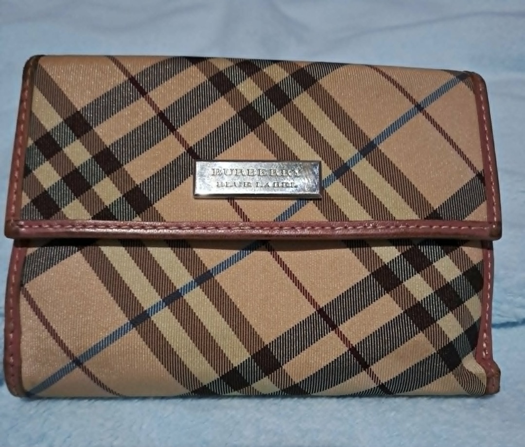 Burberry Blue Label Nova Check Wallet (Category: Luxury Bags & Wallets) located in Pila. Submitted by ester_aurea (Listing ID 1456216501, Image 1). Description: Preloved and well used Authentic Fixed price 850.00 plus J&T SF Gcash Payment No cod - Authentic Burberry Blue Label wallet - Classic Nova Check pattern - Pink leather trim and interior - Secure snap closure - Ample card slots and bill compartment - Approximate dimensions: 7.5 inches x 4 