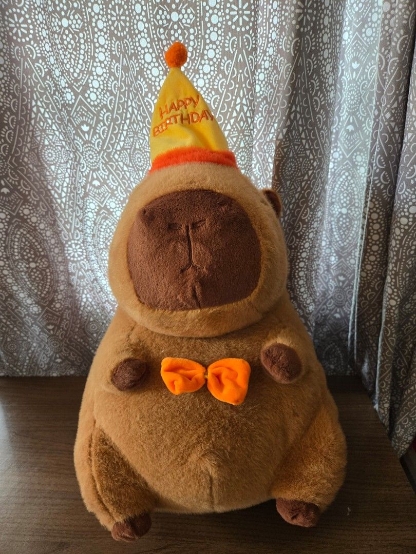 CAPYBARA Plush with Birthday Hat and Bow Tie (Category: Plushies & Soft Toys) located in Marilao. Submitted by 4dyfaith (Listing ID 1456057373, Image 1). Description: Super cute capybara plushie! location: Marilao Bulacan shipping: J&T.