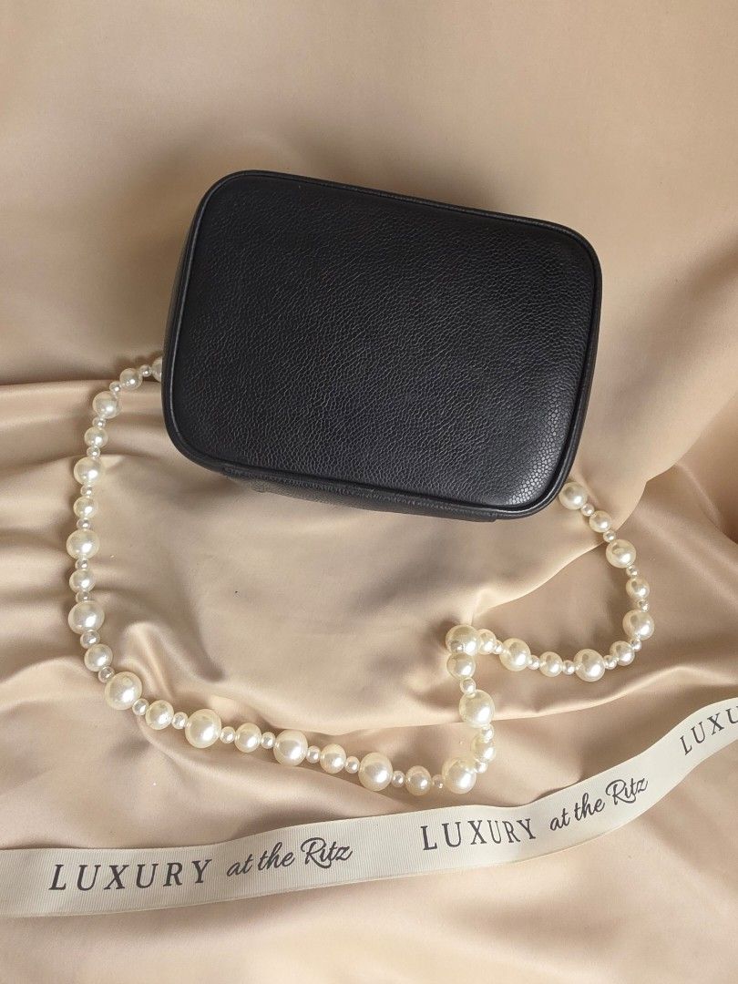 Chanel Black Caviar Vanity Case Bag with Pearl Strap (Category: Luxury Bags & Wallets) located in Makati City. Submitted by luxritz (Listing ID 1456065957, Image 2). Description: - Classic Chanel black caviar leather vanity case - Iconic embossed CC logo on the front - Comes with a beautiful pearl strap - Includes a silk scarf tied to the handle - Gold tone zipper closure - Perfect for a night out or as a statement piece Comes with Card and Box. 