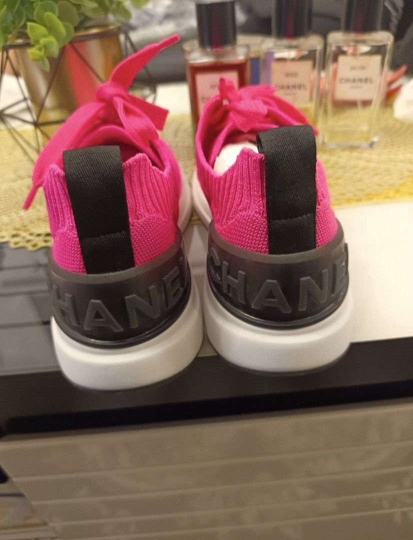 Chanel Pink Knit Sneakers (Category: Sneakers & Footwear) located in Quezon City. Submitted by melmgpy (Listing ID 1456068136, Image 3). Description: - Bright pink knit Chanel sneakers - Quilted pattern - Lace-up closure - Signature Chanel logo on tongue - 'CHANEL' text on heel counter - White sole with rubber outsole - Very eye-catching color.