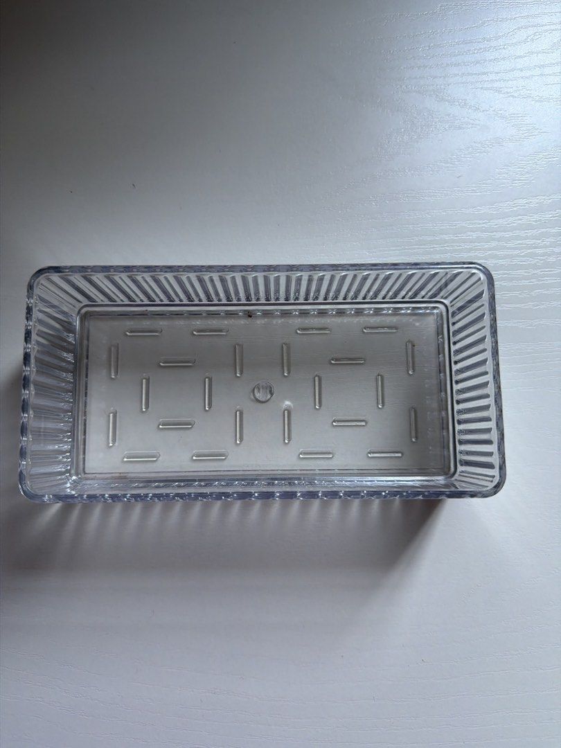 Clear Rectangular Plastic Storage Container Tray (Category: Storage Boxes & Baskets) located in Singapore. Submitted by ariana_bb (Listing ID 1456062680, Image 1). Description: - Clear plastic tray - Ribbed sides for durability - Patterned base with small indentations - Perfect for organizing small items - Versatile for drawers or shelves - Easy to clean - Approx. [insert dimensions here if known].