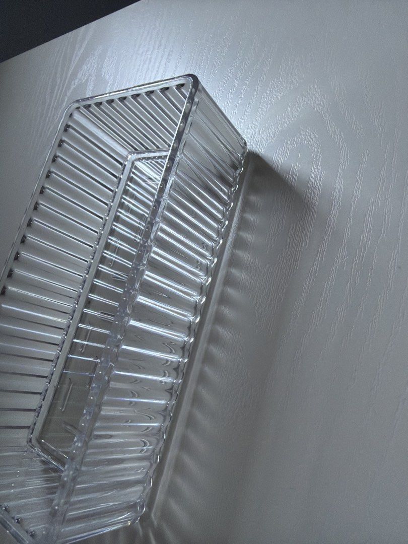 Clear Rectangular Plastic Storage Container Tray (Category: Storage Boxes & Baskets) located in Singapore. Submitted by ariana_bb (Listing ID 1456062680, Image 3). Description: - Clear plastic tray - Ribbed sides for durability - Patterned base with small indentations - Perfect for organizing small items - Versatile for drawers or shelves - Easy to clean - Approx. [insert dimensions here if known].