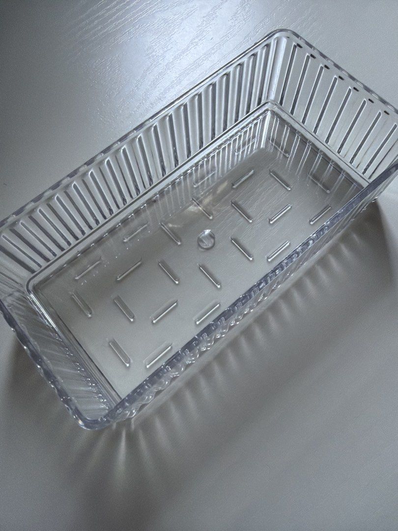 Clear Rectangular Plastic Storage Container Tray (Category: Storage Boxes & Baskets) located in Singapore. Submitted by ariana_bb (Listing ID 1456062680, Image 2). Description: - Clear plastic tray - Ribbed sides for durability - Patterned base with small indentations - Perfect for organizing small items - Versatile for drawers or shelves - Easy to clean - Approx. [insert dimensions here if known].